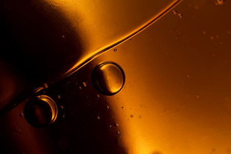 surface of oil or serum with bubbles. festive cosmetic background. Blurred background