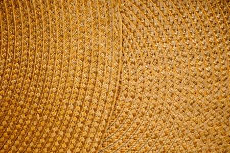 Texture of a woven rug close-up, handmade straw weaving. Rustic Table Mat, Round Dining Mat.の写真素材
