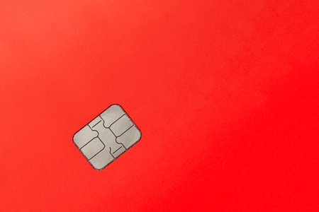 Red credit card with chip. Financial background for textの写真素材