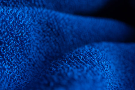Soft blue color cotton towel backdrop, fabric background. Terry cloth bath or beach towels. Macro.の写真素材