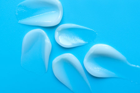 face cream on a blue background. Smear of cosmetic product on a light background