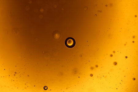 surface of oil or serum with bubbles. festive cosmetic background. Blurred backgroundの写真素材