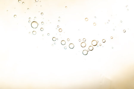 surface of oil or serum with bubbles. festive cosmetic background. Blurred background