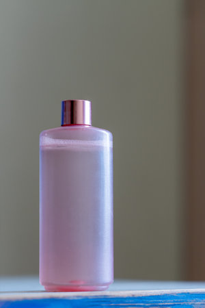 Natural cosmetic product for facial care and spa treatments. A bottle of facial emulsion stands on the surfaceの写真素材