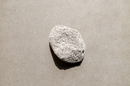 White pumice stone, on gray surface. Mineral porous stone for foot care