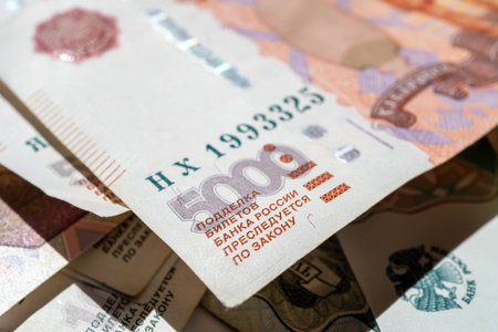 Money is scattered on the surface. Close-up of denominations of five thousand Russian rubles
