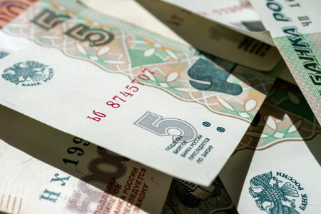 Money is scattered on the surface. Close-up of denominations of five Russian rubles