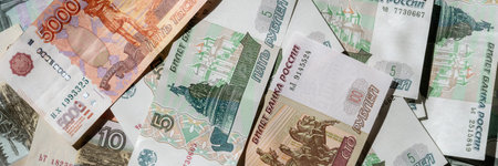 Paper banknotes of Russian rubles of different denominations in a stack close-up. Web banner