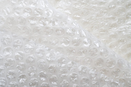 Wrapping an item in textured bubble wrap for shipping. non-ecological packaging of goods for your...