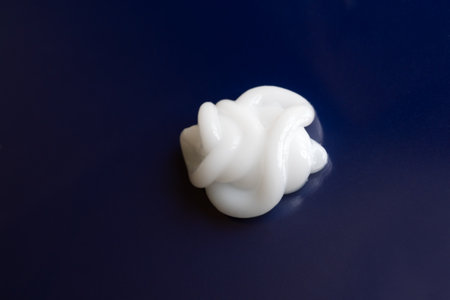 cosmetic smears cream texture on a blue backgroundの写真素材