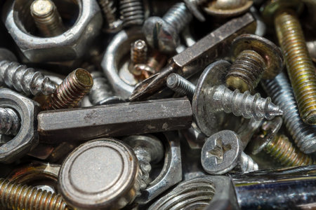 Bolts screws nuts of different sizes close-up. Macrophotography. Texture or background. Selective focus.の写真素材