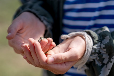 A small gray lizard on the woman's arm.