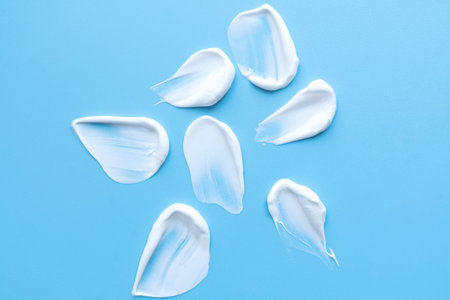 face cream on a blue background. Smear of cosmetic product on a light background