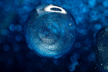 surface of oil or serum with bubbles. festive cosmetic background. Blurred backgroundの写真素材