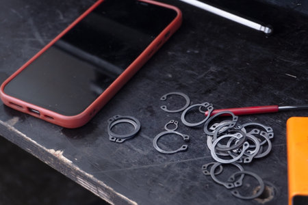 phone on table with rings in workshop
