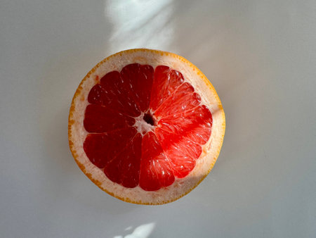 juicy bright red grapefruit cut into two parts on a white background. High quality photoの写真素材