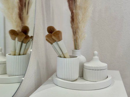 makeup brushes on the women's dressing table in a modern and stylish interior. High quality photoの写真素材