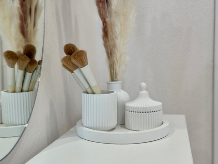 makeup brushes on the women's dressing table in a modern and stylish interior. High quality photoの写真素材