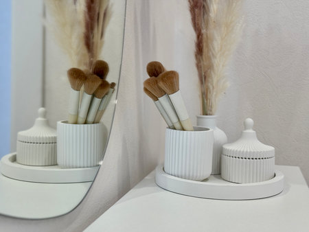 makeup brushes on the women's dressing table in a modern and stylish interior. High quality photoの写真素材