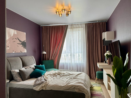 a modern bedroom in a stylish interior of a new apartment with designer renovation. High quality photoの写真素材