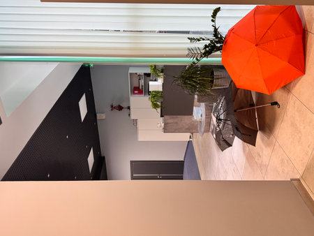 Interior of a modern hotel room with reception desk and orange umbrellaの写真素材
