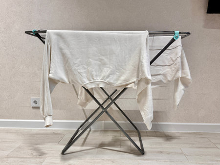 White clothes are dried on the rack at home. High quality photoの写真素材