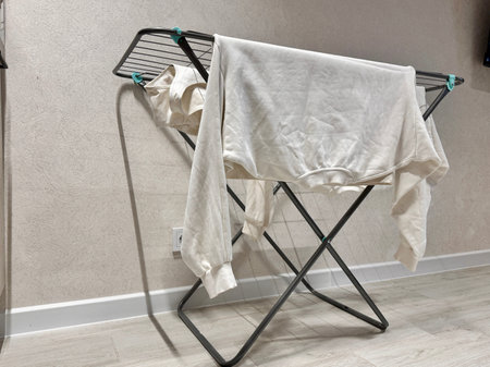 White clothes are dried on the dryer at home. High quality photo