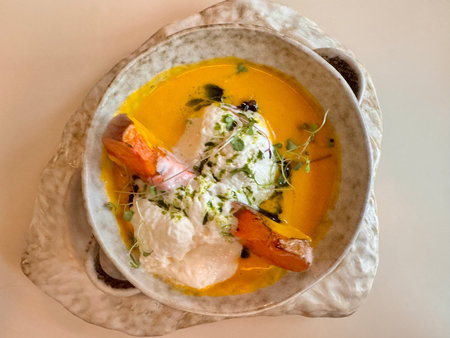 Pumpkin soup with pumpkin seeds and baked pumpkin in the restaurant. High quality photoの写真素材