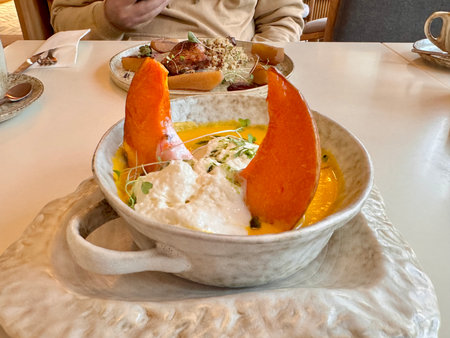 Pumpkin soup with pumpkin seeds, cream and baked pumpkin in the restaurant. High quality photoの写真素材