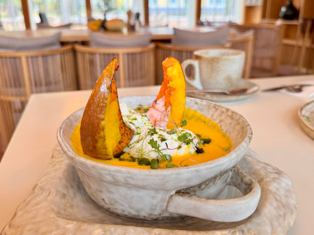 Pumpkin soup with pumpkin seeds and baked pumpkin in the restaurant. High quality photoの写真素材