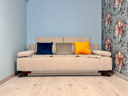 Beige sofa with colorful pillows in the apartment. High quality photoの写真素材