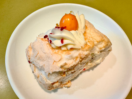 juicy and delicious dessert meringue roll on a white porcelain plate. High quality photoの写真素材