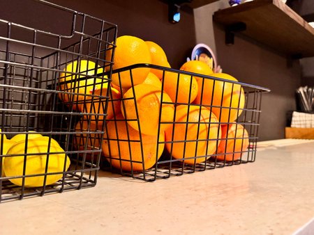 juicy oranges in a basket on the shelf.の写真素材