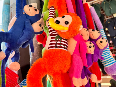A toy of colorful monkeys is hanging in the store. High quality photo