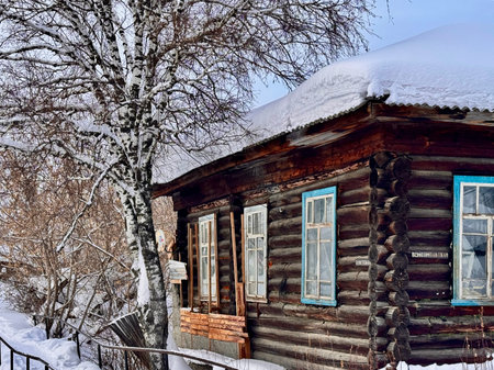 Russia, Verkhoturye January 31, 2026 traditional Russian log cabin with carved architraves in winter in the village. High quality photoのeditorial素材