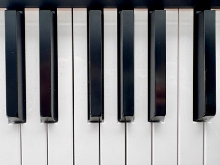 A stylish modern synthesizer for musicians is located indoors. High quality photo
