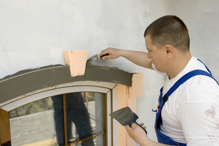 plasterer inflicts mortar on architectural elementの写真素材