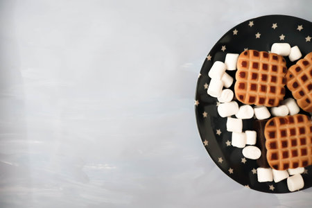 Cookies and a lot of marshmallows on a light background.の写真素材