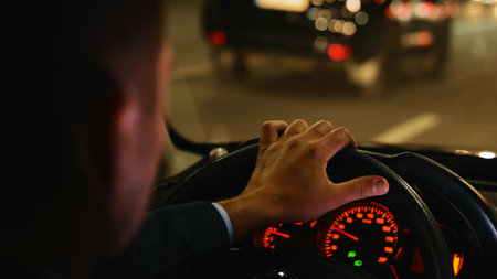 Man driving car fast in night city street with traffic. Road trip, driver concept. Commuter, male...