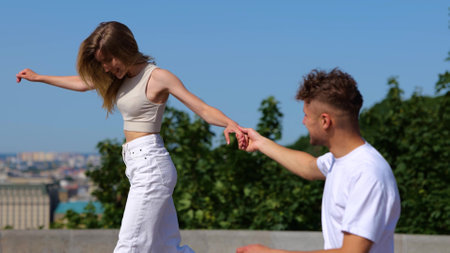 Romantic couple walking in the city. Happy beautiful young woman and handsome man having fun outdoors. Bonding, love and relationship concept. Real timeの写真素材