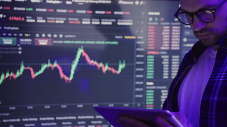 Male investors analyzing market stock while holding digital tablet. Slow motion