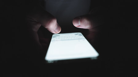 Hands of man chatting on the mobile phone, typing message. Slow motionの写真素材