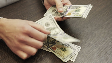 Male hands counting money American dollars. Top view. Close up. Slow motion