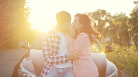 Happy man hugging his girlfriend near the car. Slow motionの写真素材
