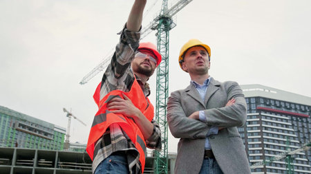 Building contractors discussing something during site inspection