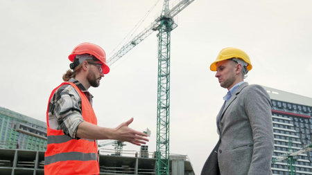 General contractor greeting subcontractor on building site