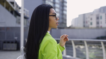 Pretty lady looking at beautiful nature near business centerの写真素材
