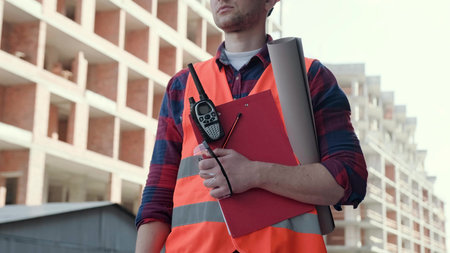 Experienced site supervisor inspecting new building in morningの写真素材