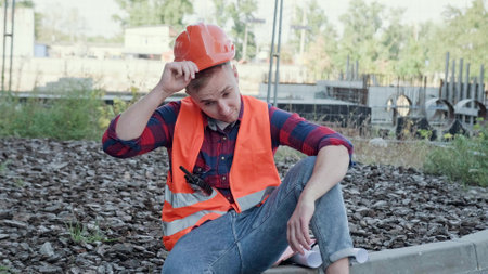 Weary young builder suffering from overwork on building siteの写真素材