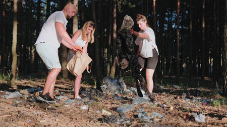 People picking up plastic bottle, garbage collecting in a forestの写真素材